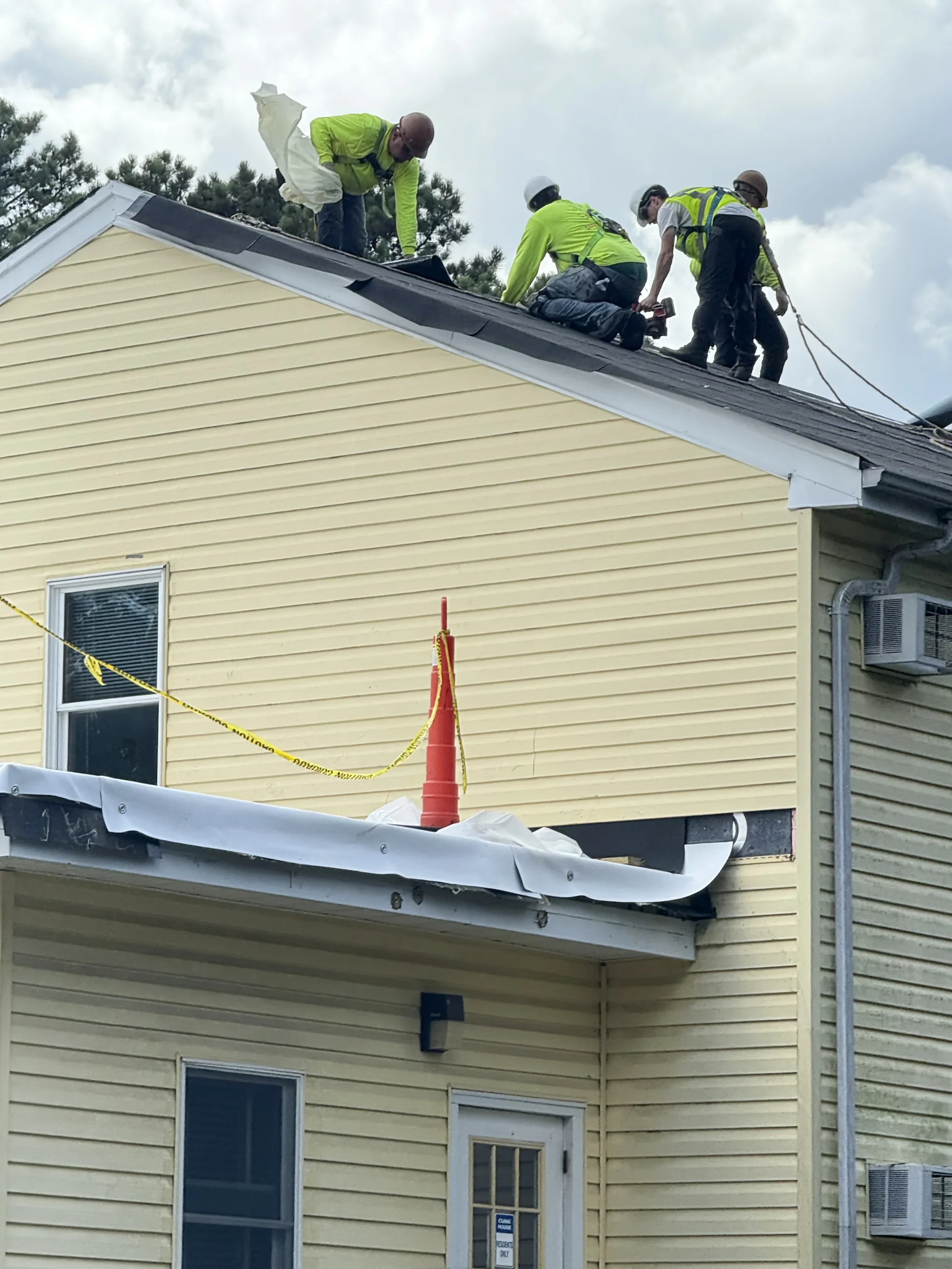 Roofers on building at Brookhaven