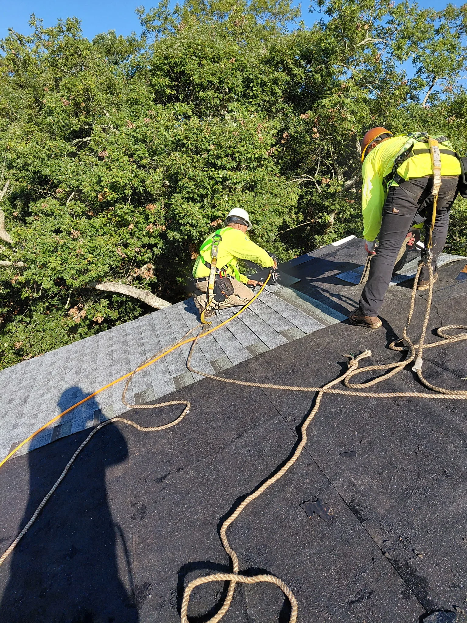 Roofers with safety harnesses at Brookhaven